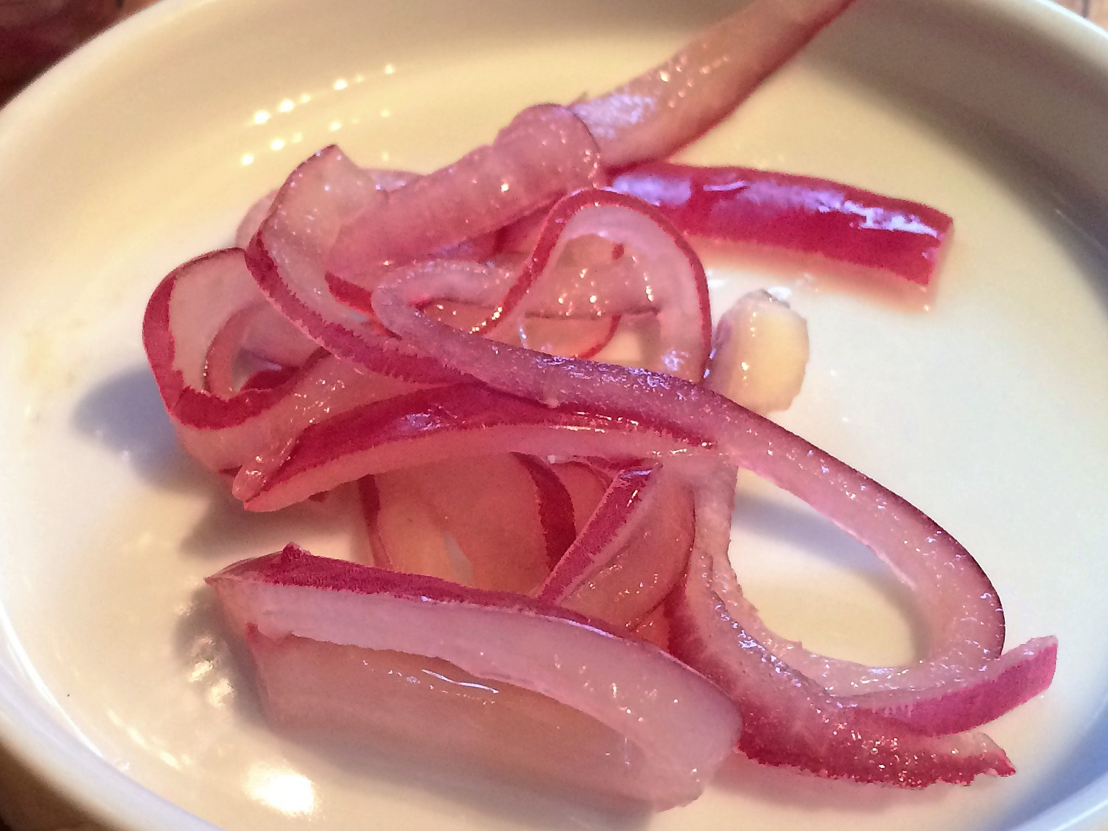 These pickled red onions are a tangy, slightly sweet, and downright magical addition to tacos, sandwiches, or anything that needs a zing of flavor. Quick, simple, and a total flavor bomb!