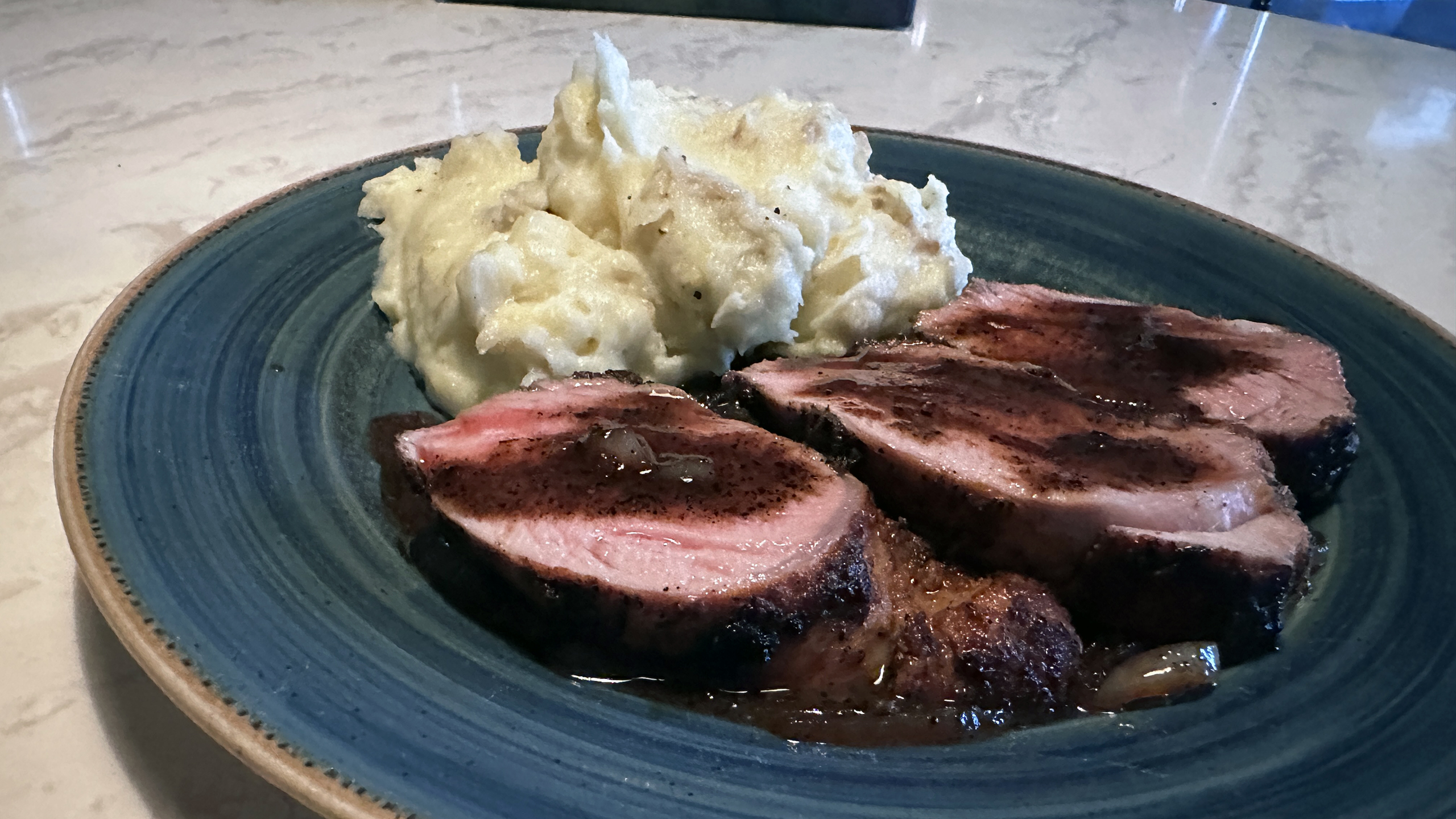 A perfectly seared pork tenderloin finished in the oven and topped with a rich, glossy Madeira sauce. This dish is surprisingly simple and seriously impressive.